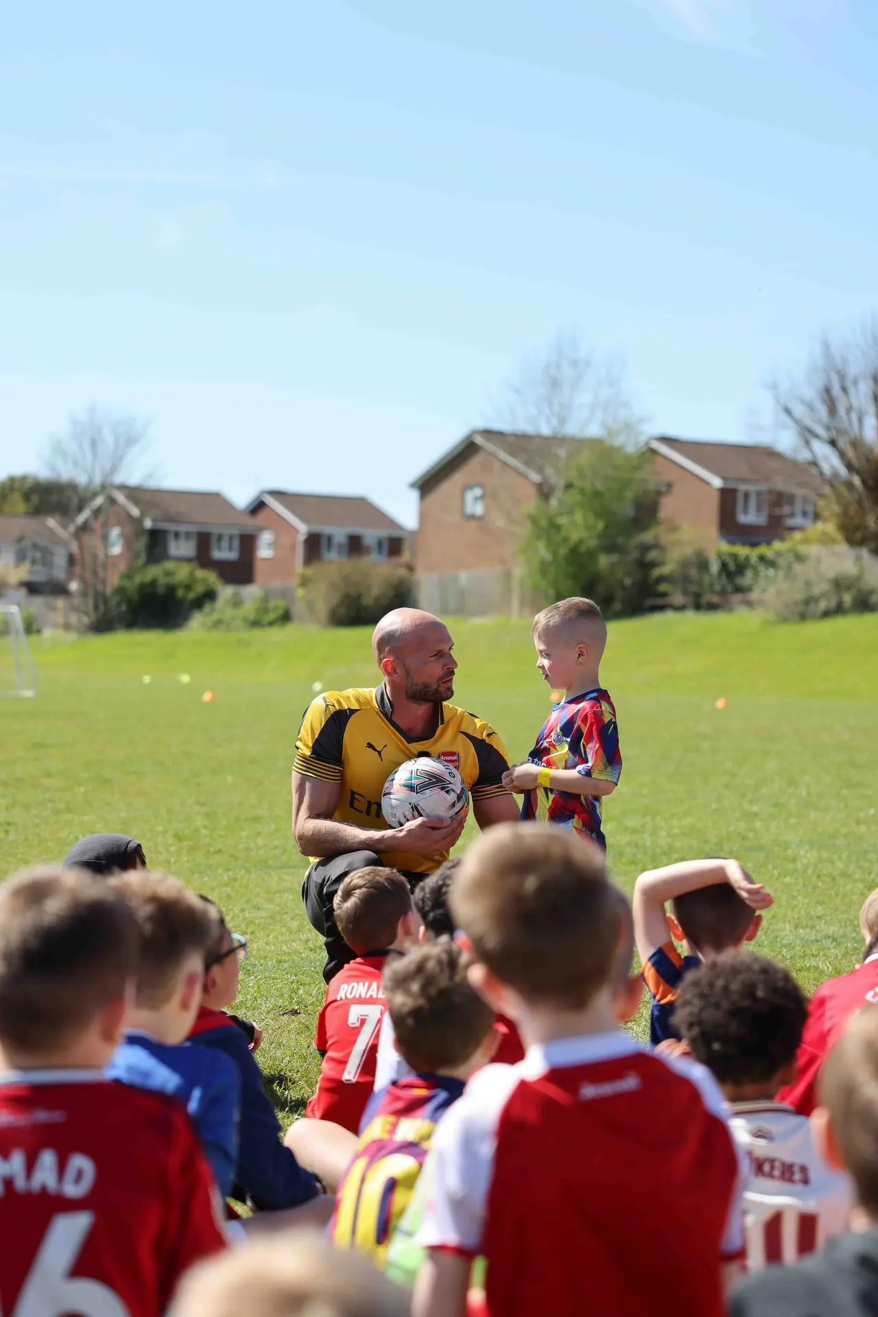 Daniel with a camper and a football