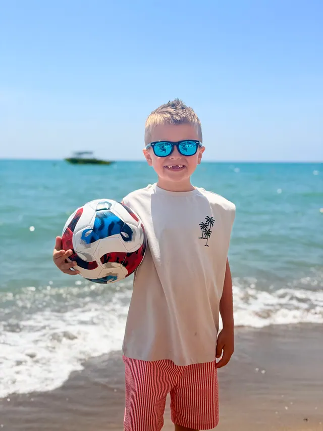 Joshua with a football on the beach